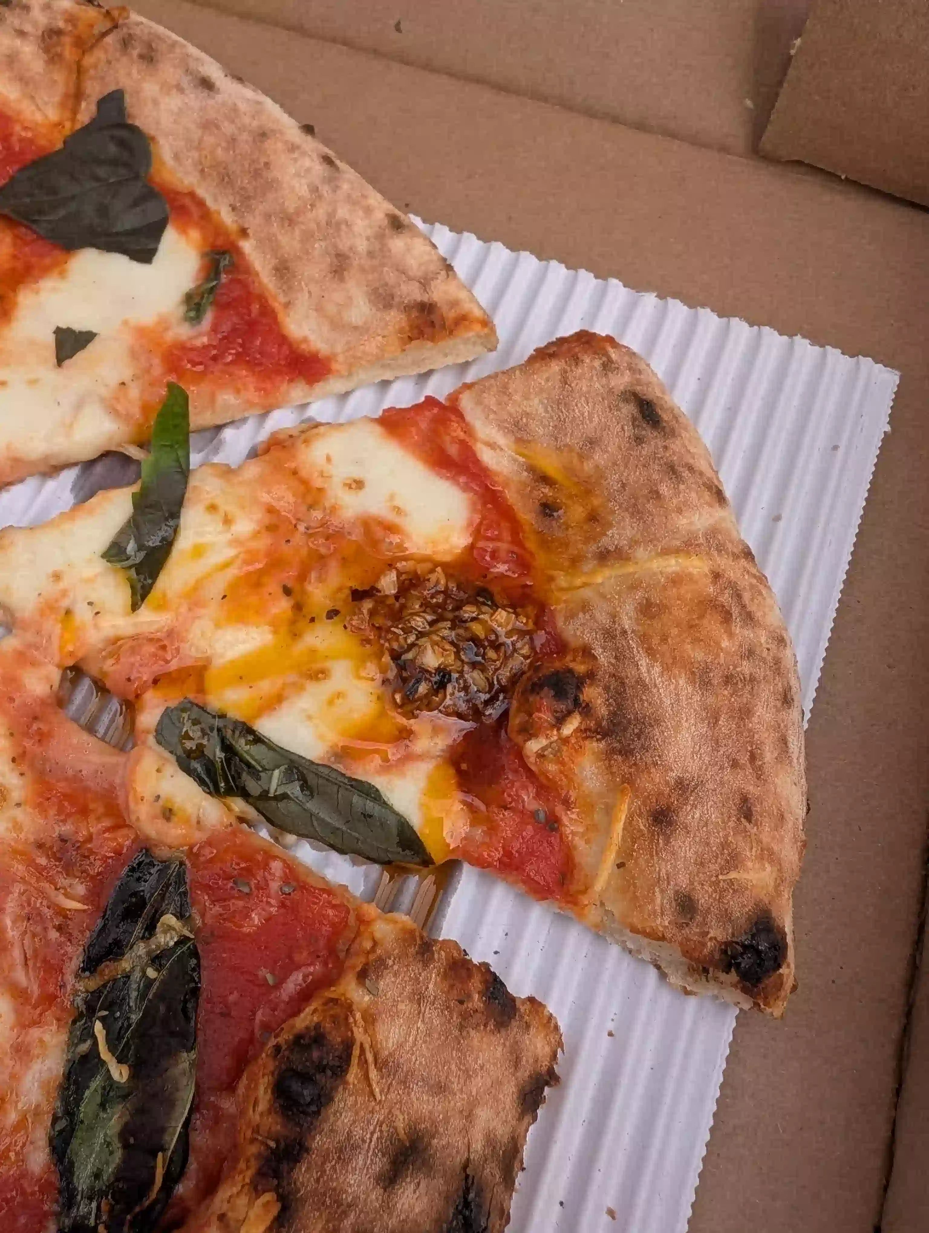 Slices of pizza with basil and chili oil